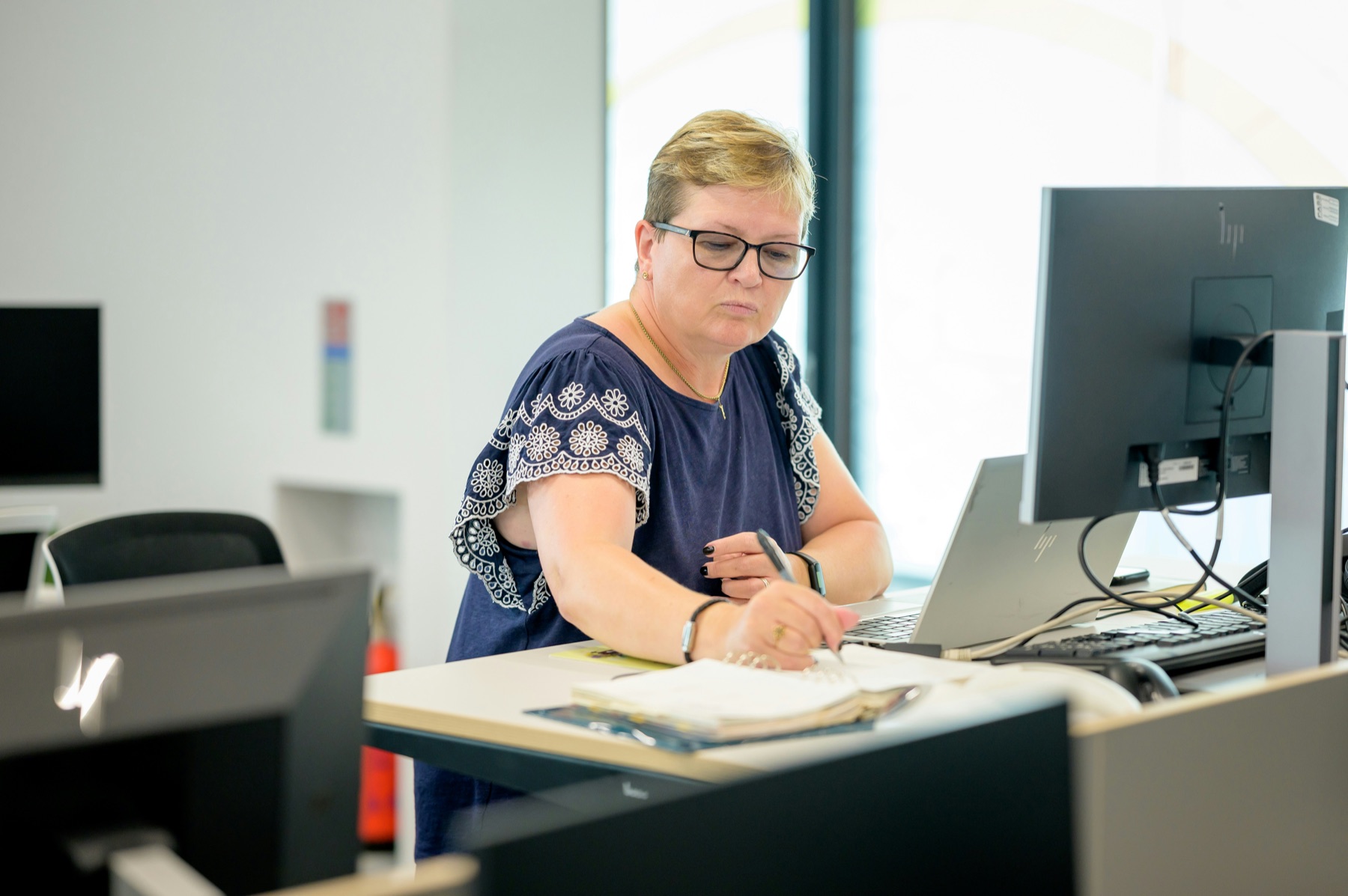 CPA reviewing tax and accounting paperwork at a workstation