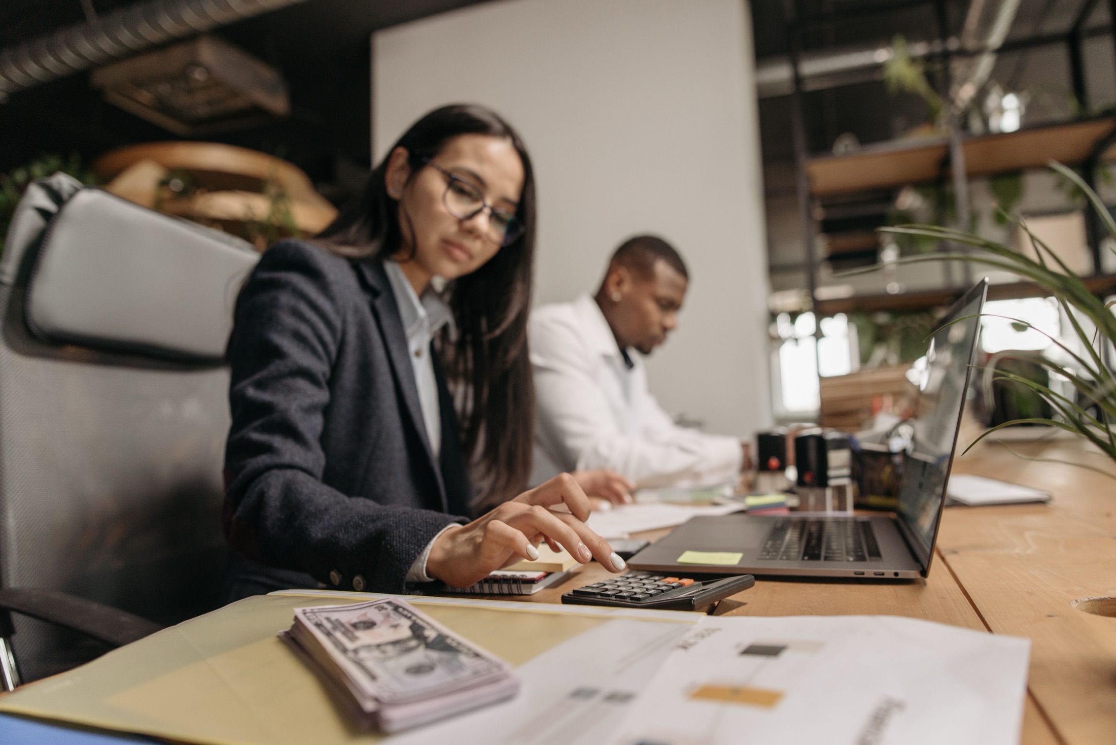 Tax and accounting professionals reviewing client documents in an office